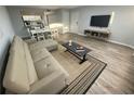Bright living room with a couch, dining table, and gray flooring at 3147 Britannia Blvd # A, Kissimmee, FL 34747