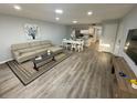 Comfortable living room with modern decor, dining table, and hard surface floors at 3147 Britannia Blvd # A, Kissimmee, FL 34747