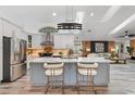 Bright open kitchen with large center island, stainless appliances and modern pendant lighting at 335 Debary Ave, Debary, FL 32713