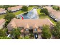 Aerial view of townhomes with a community pond at 3567 Shallot Dr # 103, Orlando, FL 32835