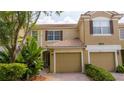 Charming townhome featuring a brick driveway, tile roof, and lush landscaping at 3567 Shallot Dr # 103, Orlando, FL 32835