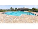 Community pool with an aqua blue color and a covered patio area for residents at 3829 Allegany Ln, Sanford, FL 32771