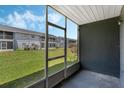 Relaxing screened patio overlooking the green lawn in the community at 4136 Pershing Pointe Pl # 2, Orlando, FL 32822