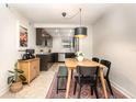 Cozy dining area with a view of the modern kitchen, complemented by stylish furniture and decor at 4332 Lake Underhill Rd # 12D10, Orlando, FL 32803