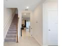 Inviting foyer with staircase and view into the living area at 4725 Coral Castle Dr, Kissimmee, FL 34746