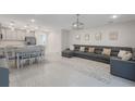Open-concept living room with modern furniture and neutral decor at 4725 Coral Castle Dr, Kissimmee, FL 34746