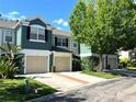 Inviting townhomes featuring two-car garages and lush landscaping, enhancing the curb appeal at 5114 Hawkstone Dr, Sanford, FL 32771