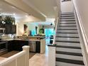 Open concept kitchen with dark cabinetry, granite countertops, and stainless steel appliances at 5114 Hawkstone Dr, Sanford, FL 32771