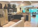 Spacious kitchen featuring dark cabinetry, granite countertops, and stainless steel appliances at 5114 Hawkstone Dr, Sanford, FL 32771