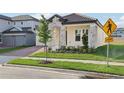 Charming single-story home features a stone facade, tile roof and manicured lawn at 5254 Citrus Leaf Blvd, Winter Garden, FL 34787