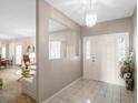 Inviting entryway with decorative tiled floor, chandelier, and views into the living room at 7540 Lake Marsha Dr, Orlando, FL 32819