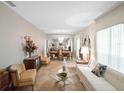 Spacious living room and dining room featuring a large mirrored wall and elegant chandelier at 7540 Lake Marsha Dr, Orlando, FL 32819