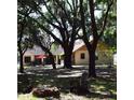 Lush backyard oasis featuring mature trees, a fire pit, and outdoor seating at 859 Morning Star Dr, Lakeland, FL 33810