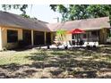 Secluded backyard featuring a fountain, ample seating, and lush tropical plants at 859 Morning Star Dr, Lakeland, FL 33810