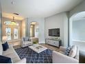 Inviting living room with neutral tones, stylish furniture, and an open layout, perfect for entertaining at 903 Kersfield Cir, Lake Mary, FL 32746