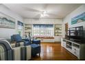 Bright living room with hardwood floors, a window seat, built-in shelving, and comfortable seating at 1000 Pennsylvania Ave, Lakeland, FL 33803