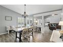 Open dining room with hardwood floors, chandelier, views of pool, and lots of natural light at 1129 Golfside Dr, Winter Park, FL 32792