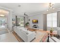Bright living room with light gray walls, hardwood floors, stylish lighting and neutral modern furniture at 12936 Freeman St, Windermere, FL 34786
