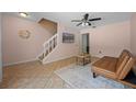 Inviting living area showcasing tile floors, a staircase, and a comfortable seating arrangement at 130 Kristi Ann Ct, Winter Springs, FL 32708