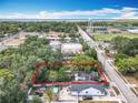 Aerial view of the home within a defined property line, near the lake and water tower at 1314 S Mellonville Ave, Sanford, FL 32771