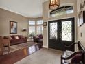 Inviting front foyer with decorative glass front door, tile floors, and views into the living room at 14315 Letham Grange Ct, Orlando, FL 32828