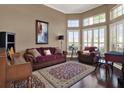 Living room featuring large windows, hardwood flooring, comfortable furniture, and neutral paint at 14315 Letham Grange Ct, Orlando, FL 32828