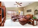 Comfortable living room featuring a leather sectional, a bright window, and a view into the foyer at 1457 Waukon Cir, Casselberry, FL 32707