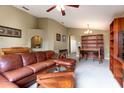 Cozy living room with a leather sectional, a decorative archway, and a built-in bookcase at 1457 Waukon Cir, Casselberry, FL 32707