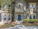 Charming condo entrance with a blue front door, a lovely garden, and a covered porch at 163 Villa Di Este Ter # 105, Lake Mary, FL 32746