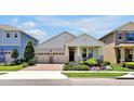Charming single-story home featuring a well-manicured front yard, a two-car garage, and a welcoming covered entry at 16527 Sea Glass St, Winter Garden, FL 34787