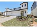 Charming two-story home featuring a paved driveway, attached garage, and landscaped front yard at 1812 Archer Dr, Minneola, FL 34715