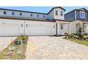 Charming two-story home featuring a paved driveway, attached garage, and landscaped front yard at 1812 Archer Dr, Minneola, FL 34715