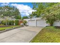 Two-car detached garage with concrete driveway and low shrubbery at 1845 Delaney Ave, Orlando, FL 32806