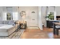 Bright living room with hardwood floors, white walls, and stylish decor. Windows offer natural light at 1845 Delaney Ave, Orlando, FL 32806