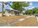 A cozy single-story home with a well-maintained front yard and mature tree, offering shade and curb appeal at 1993 Excalibur Dr, Orlando, FL 32822