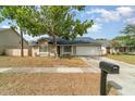 A well-maintained single-story home featuring a tidy front yard and an attached two-car garage at 1993 Excalibur Dr, Orlando, FL 32822