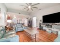 Open-concept living room boasts wood floors and a large entertainment center at 1993 Excalibur Dr, Orlando, FL 32822