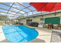 Beautiful backyard pool with outdoor seating and lush landscaping at 1993 Excalibur Dr, Orlando, FL 32822