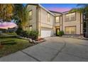 Charming two-story home with well-maintained landscaping and a two car garage at 2260 The Oaks Blvd, Kissimmee, FL 34746