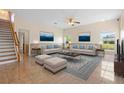 Cozy living room showcasing elegant furnishings, wainscoting, and a staircase at 2260 The Oaks Blvd, Kissimmee, FL 34746