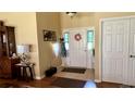 Bright foyer features neutral walls, tile floors, and a white front door adorned with a decorative wreath at 24125 Peekskill St, Leesburg, FL 34748