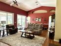 Inviting living room boasts high ceilings, a ceiling fan, and sliding glass doors for seamless indoor-outdoor living at 24125 Peekskill St, Leesburg, FL 34748
