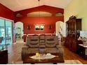 Comfortable living room with high ceilings, hardwood floors, and stylish furniture at 24125 Peekskill St, Leesburg, FL 34748