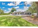 Contemporary home boasts a manicured lawn, complemented by the home's sleek lines and modern landscape design at 2525 Venetian Way, Winter Park, FL 32789