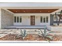 Front porch with striking front door and stone accents and landscape at 2525 Venetian Way, Winter Park, FL 32789