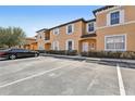 Exterior view of condo with parking and landscaping at 2718 Bushman Dr, Kissimmee, FL 34746