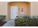 Close up of white front door with decorative window accent at 2718 Bushman Dr, Kissimmee, FL 34746
