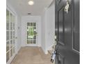 Bright foyer with tiled flooring, a glass-paneled door, and freshly painted white walls at 312 Grand Bay Ln, Celebration, FL 34747