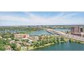 A scenic aerial view highlights the property's waterfront location, nestled among lush greenery, with the city skyline in the distance at 320 Lakeview St # 222, Orlando, FL 32804