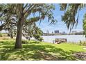 Enjoy the scenic view, shaded by trees, with a glimpse of the lake and city skyline, with bench and dock at 320 Lakeview St # 222, Orlando, FL 32804
